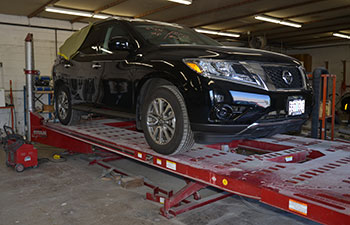 Car on a Lift at M & G Collision Specialists